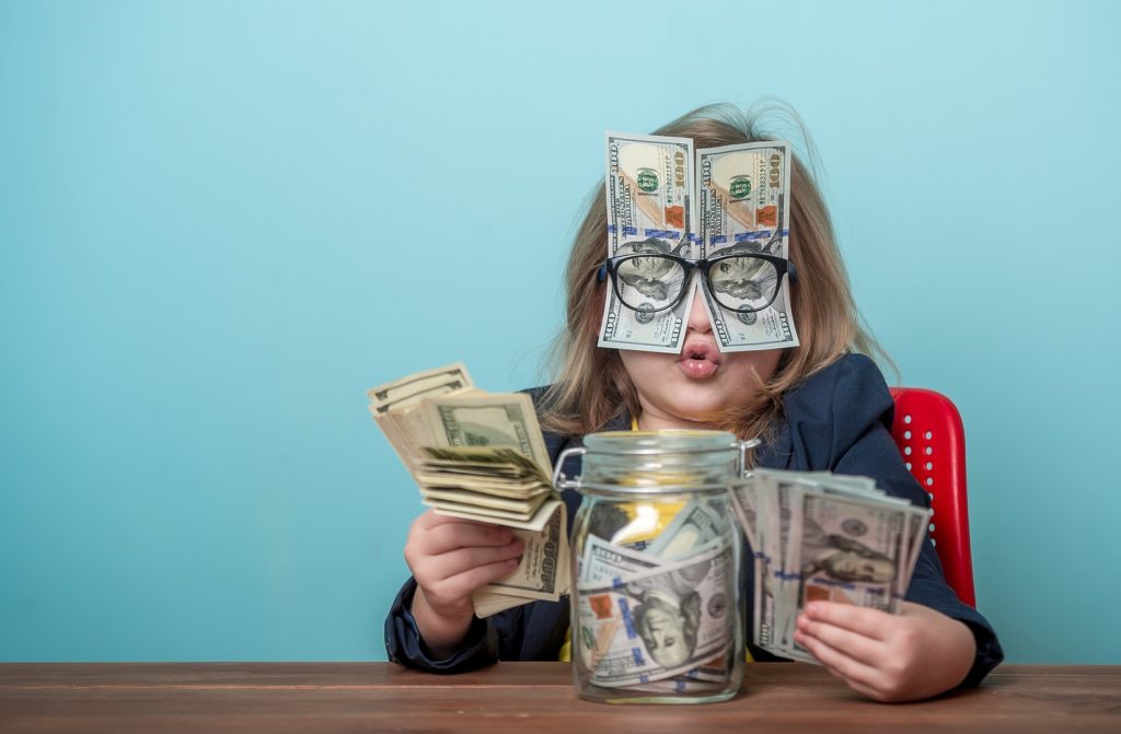 Funny picture of young girl with lots of money.
