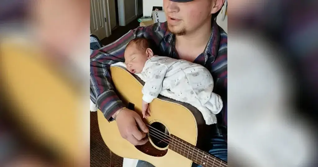 Country musician Cody Comer sings his daughter to sleep on his guitar. (Photo from Faithpot)