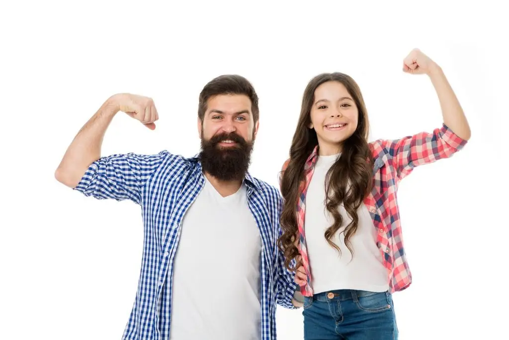 A dad and daughter showing off their muscles.