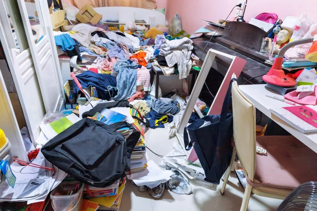 A photo of a teenage girl's cluttered and chaotic bedroom.