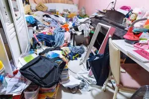 A photo of a teenage girl's cluttered and chaotic bedroom.